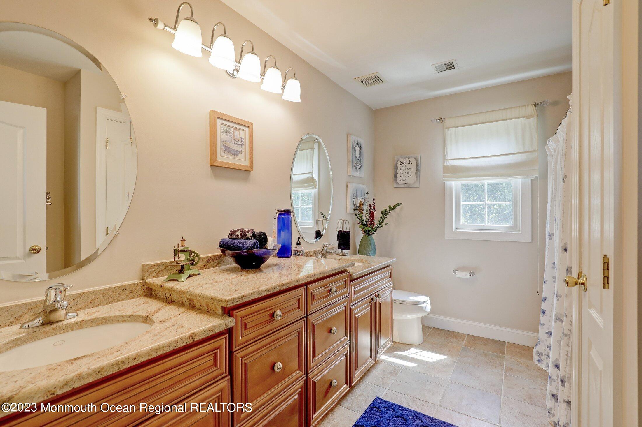 352 Lanes Pond Road Howell, NJ 07731 - Photo 36 of 67 a bathroom with a granite countertop sink mirror vanity and toilet