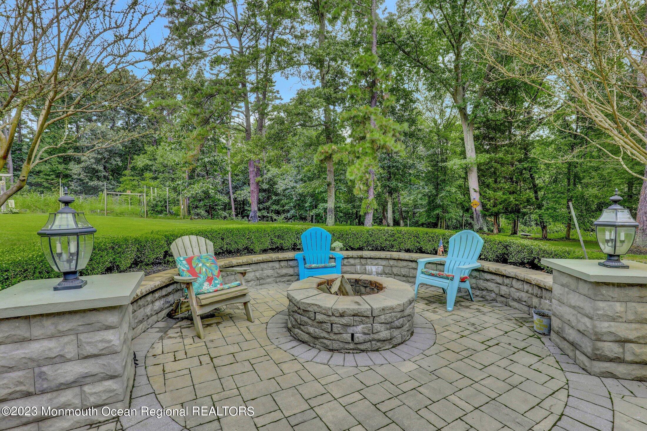 352 Lanes Pond Road Howell, NJ 07731 - Photo 49 of 67 a view of a chairs and table in backyard of the house