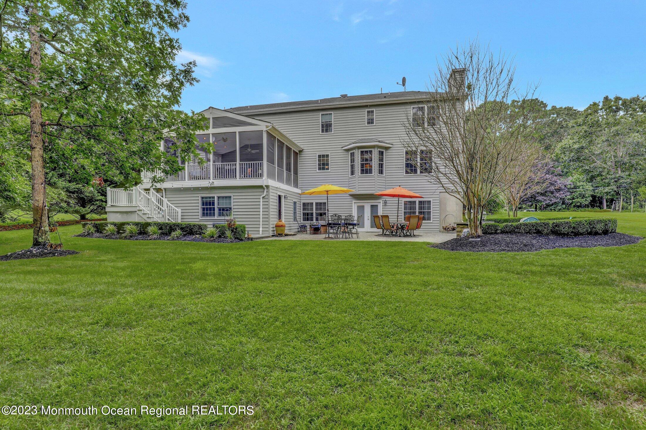 352 Lanes Pond Road Howell, NJ 07731 - Photo 54 of 67 a view of a white house with a big yard and large trees
