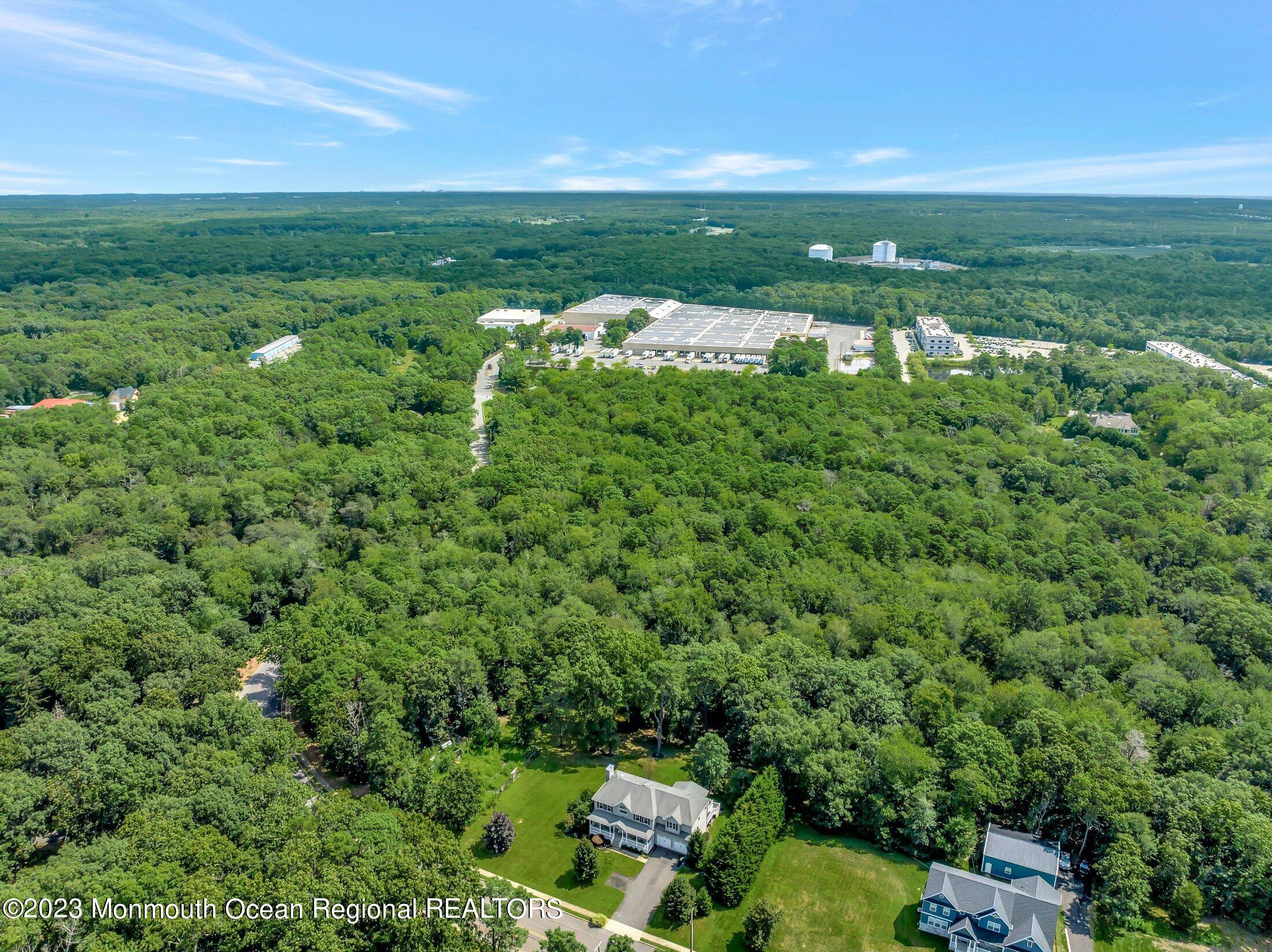 352 Lanes Pond Road Howell, NJ 07731 - Photo 60 of 67 a view of a green yard with large trees