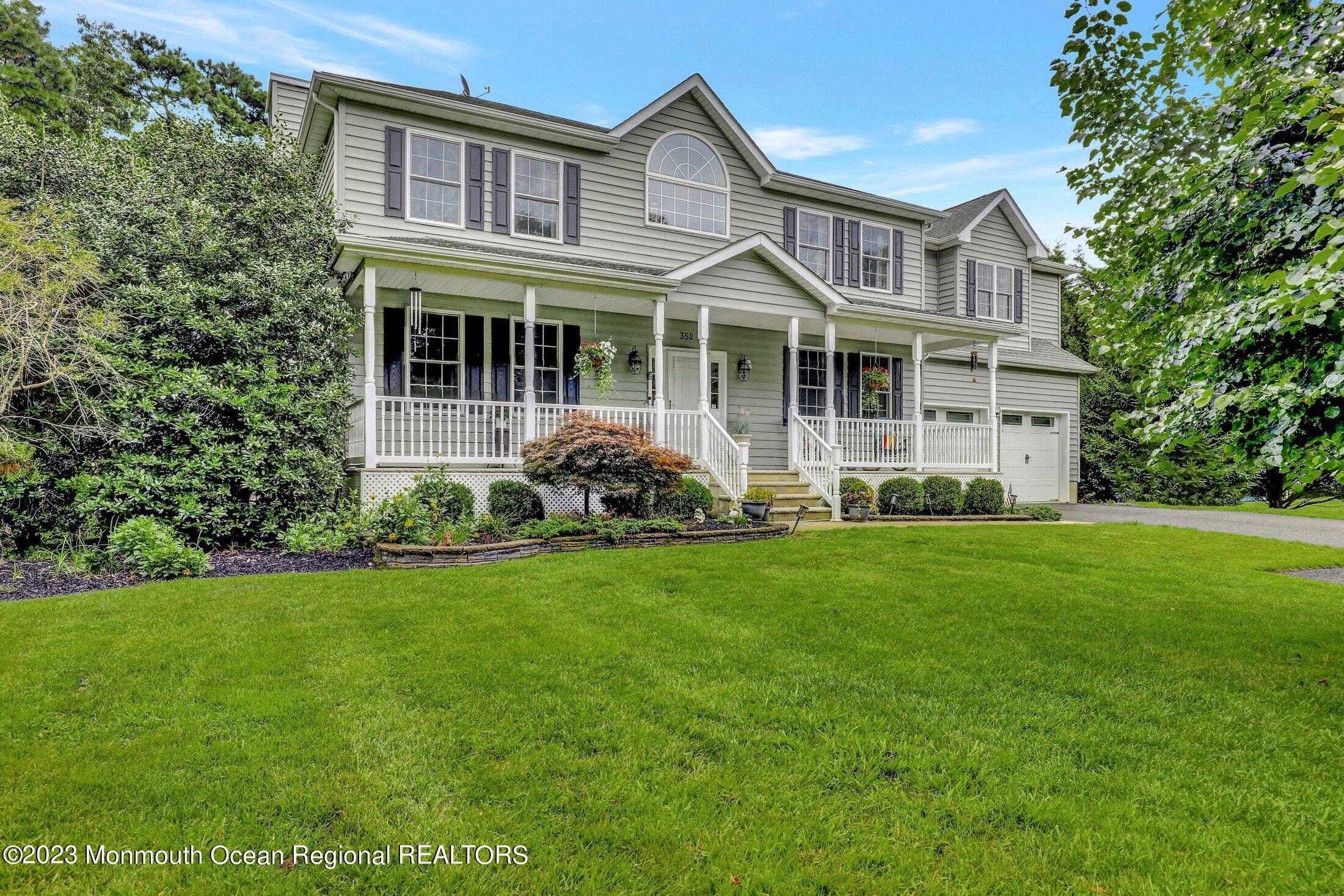 352 Lanes Pond Road Howell, NJ 07731 - Photo 6 of 67 a front view of a house with a yard