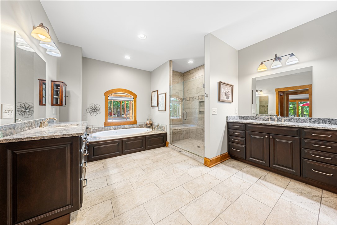 285 Bertha Allen Road Westminster, SC 29693 - Photo 18 of 50 Luxurious ensuite features dual vanities with granite counters, a tiled walk-in shower, and a relaxing soaking tub.