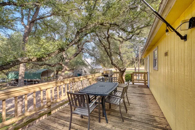 a backyard of a house with table and chairs