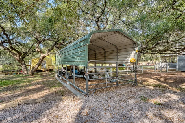 a view of a house with backyard and chairs