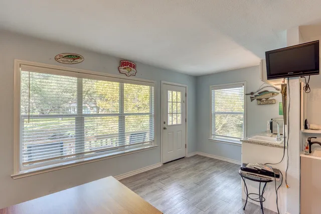 a view of a livingroom with furniture and a window