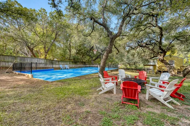 a backyard of a house with table and chairs