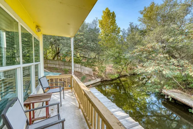 a view of balcony with mountain view and wooden floor