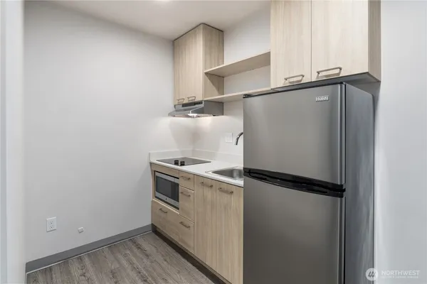 a view of an empty room with wooden floor
