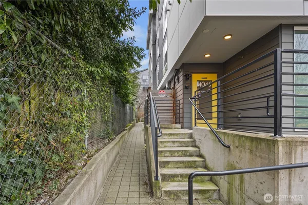 a view of a brick house with a tree