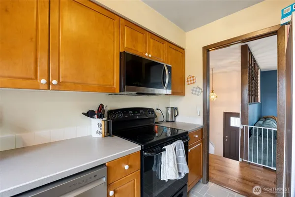 a kitchen with a sink a stove and cabinets