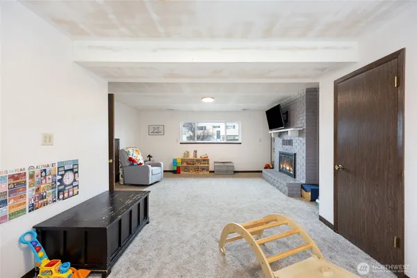 a living room with furniture and a baby crib