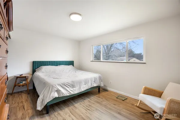a bedroom with a bed and a chair