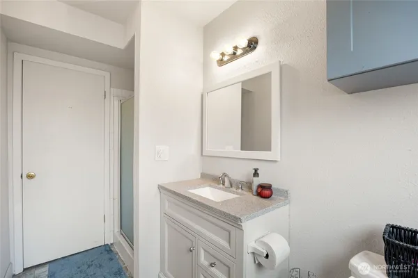 a bathroom with a sink vanity and a mirror
