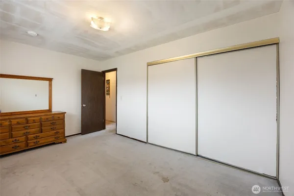 an empty room with cabinet cabinet and mirrors