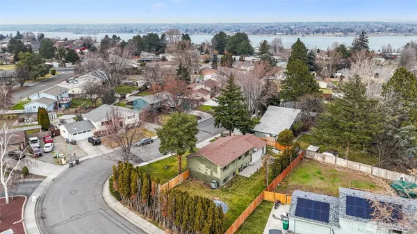 an aerial view of a house with a swimming pool outdoor seating and yard
