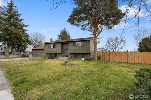 a view of house with outdoor space and garden