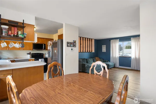 a dining room with a table chairs and entryway