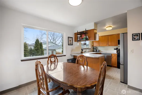 a view of a dining room with furniture window and outside view