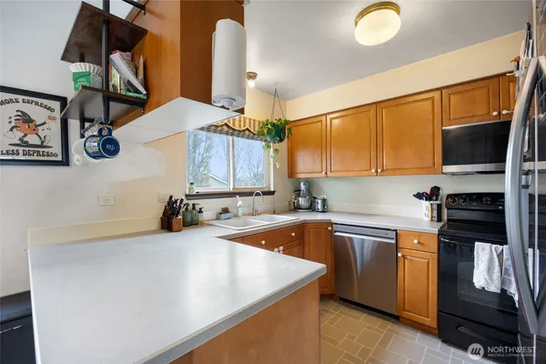 a kitchen that has a sink and a stove in it