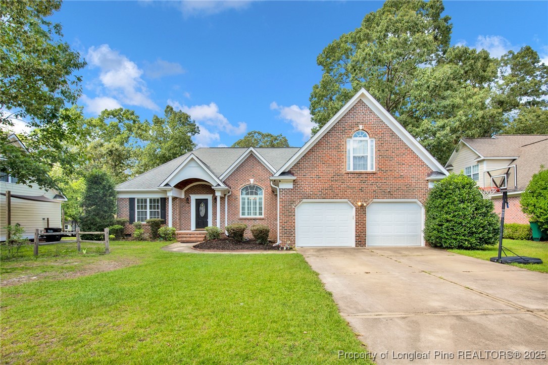 1199 Hunters Trail Hope Mills, NC 28348 - Photo 1 of 45 a front view of house with yard and green space