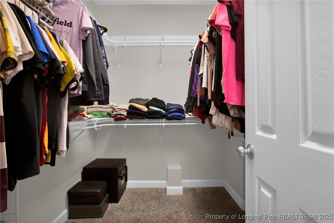 1199 Hunters Trail Hope Mills, NC 28348 - Photo 22 of 45 a view of walk in closet with clothes and shoes