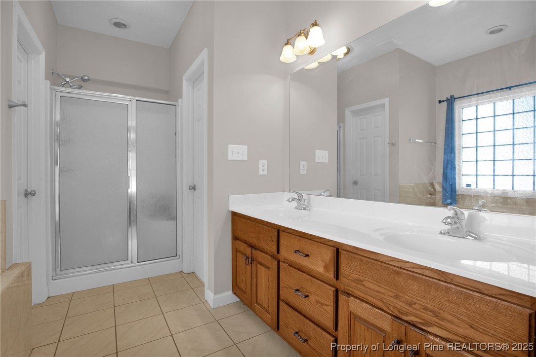 1199 Hunters Trail Hope Mills, NC 28348 - Photo 23 of 45 a bathroom with a double vanity sink and a mirror