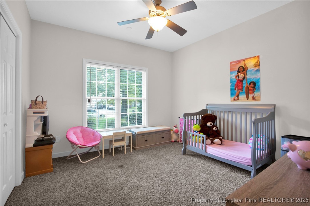 1199 Hunters Trail Hope Mills, NC 28348 - Photo 27 of 45 a bedroom with a bed and a chandelier