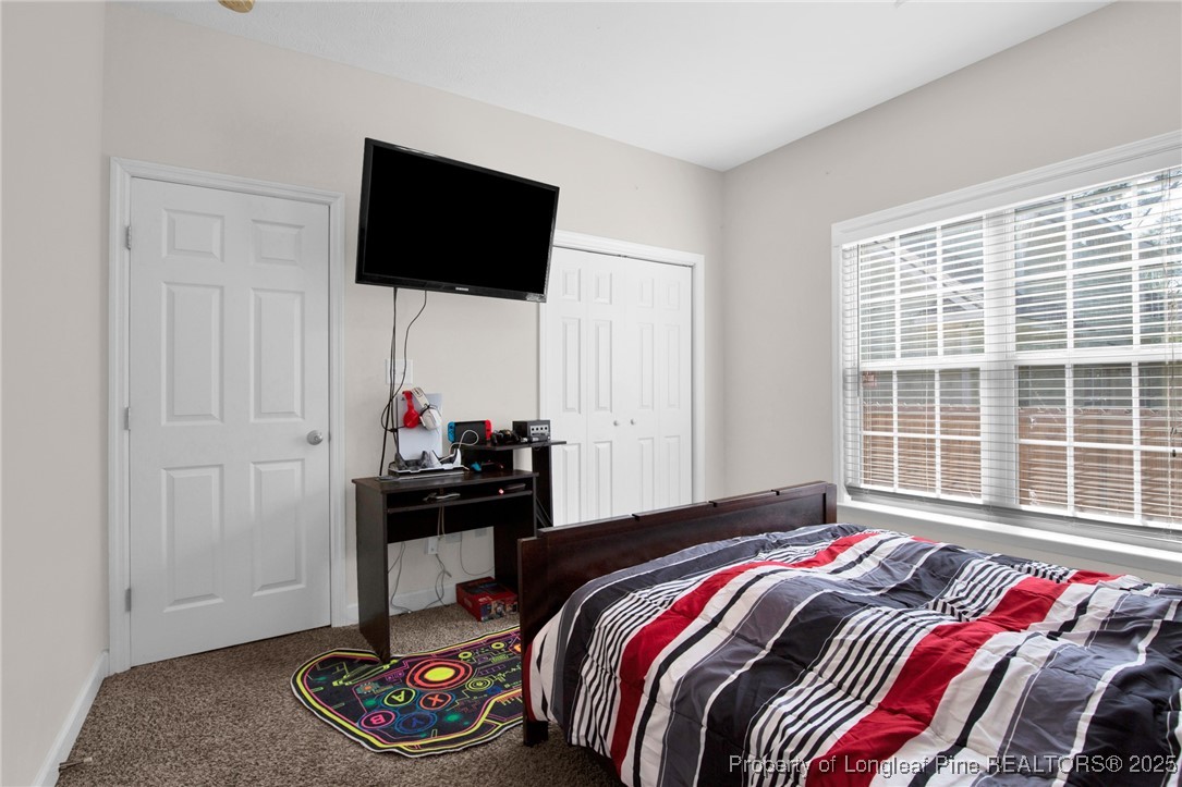 1199 Hunters Trail Hope Mills, NC 28348 - Photo 30 of 45 a bedroom with a bed and a flat screen tv