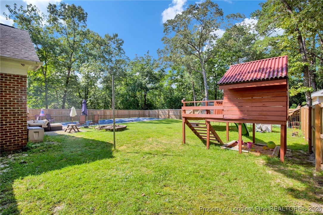 1199 Hunters Trail Hope Mills, NC 28348 - Photo 34 of 45 a view of a house with backyard and sitting area