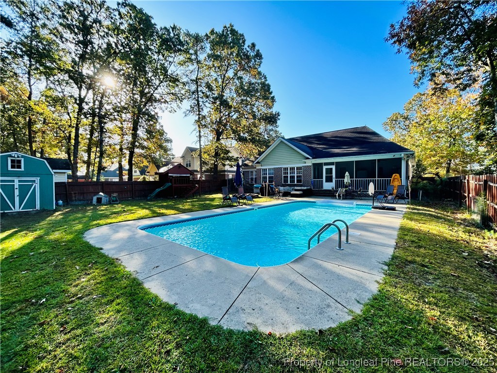1199 Hunters Trail Hope Mills, NC 28348 - Photo 36 of 45 a swimming pool with outdoor seating and yard