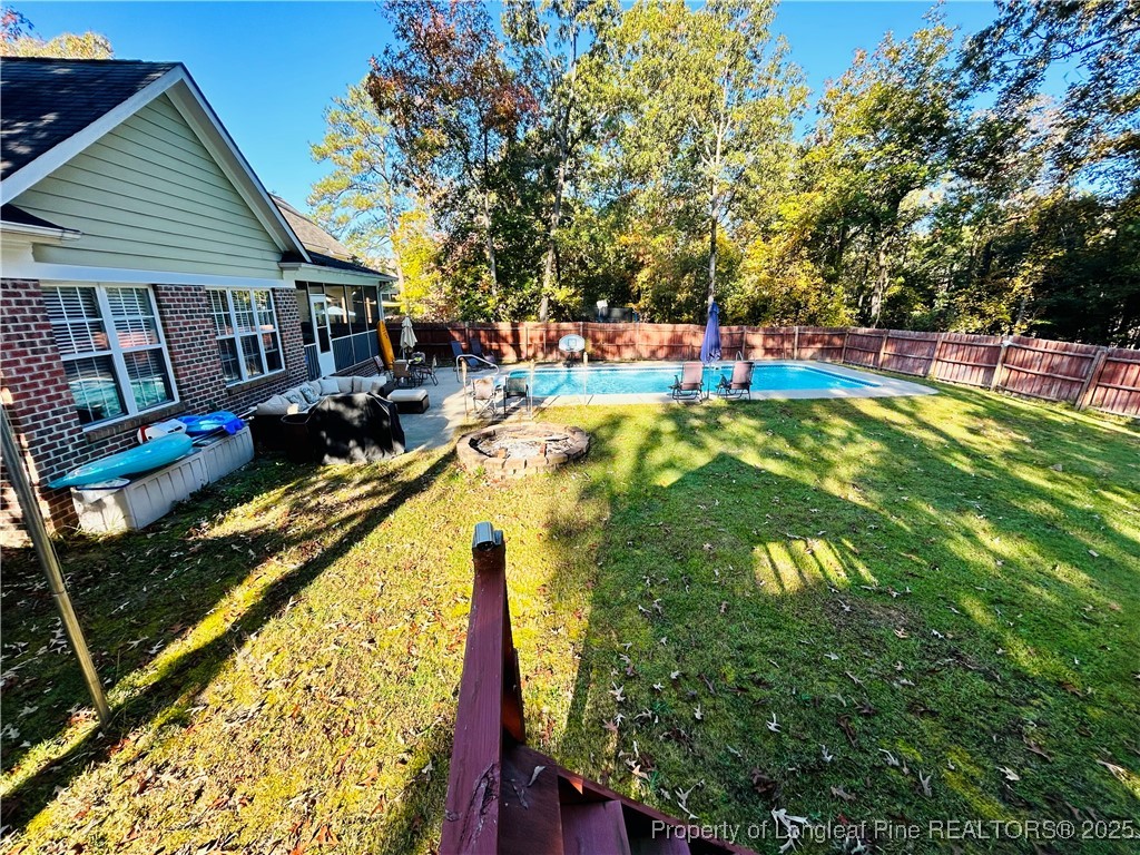 1199 Hunters Trail Hope Mills, NC 28348 - Photo 38 of 45 a view of swimming pool with a patio and a garden