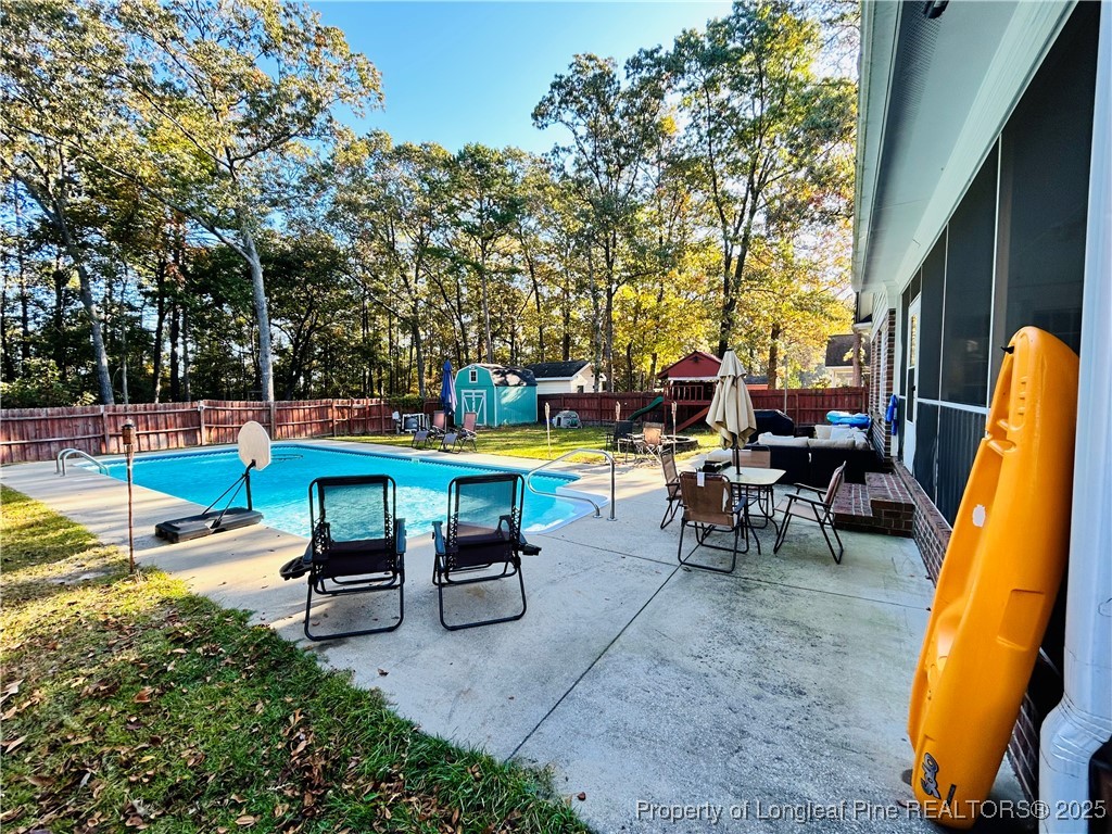 1199 Hunters Trail Hope Mills, NC 28348 - Photo 40 of 45 a backyard of a house with table and chairs