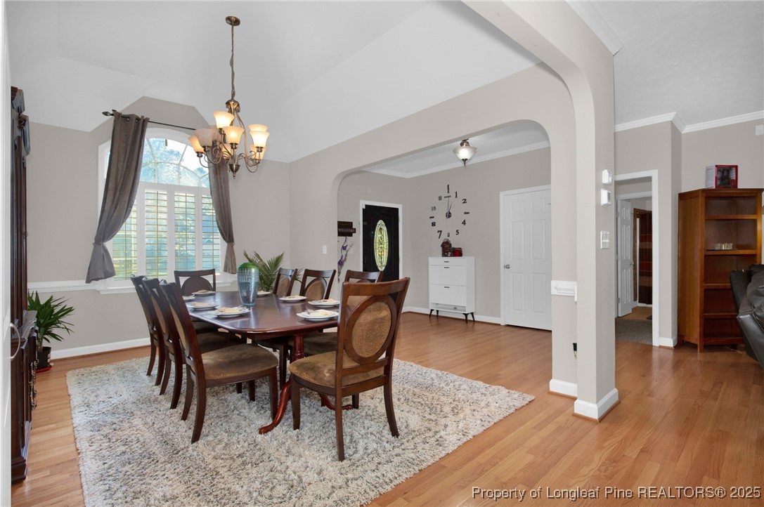 1199 Hunters Trail Hope Mills, NC 28348 - Photo 7 of 45 a view of a dining room with furniture and wooden floor