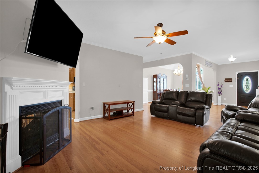 1199 Hunters Trail Hope Mills, NC 28348 - Photo 9 of 45 a living room with furniture a fireplace and a flat screen tv