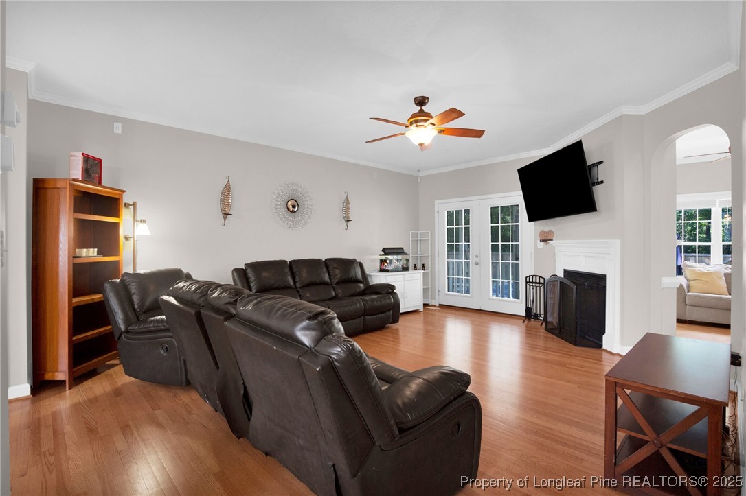1199 Hunters Trail Hope Mills, NC 28348 - Photo 10 of 45 a living room with furniture a fireplace a flat screen tv and kitchen view