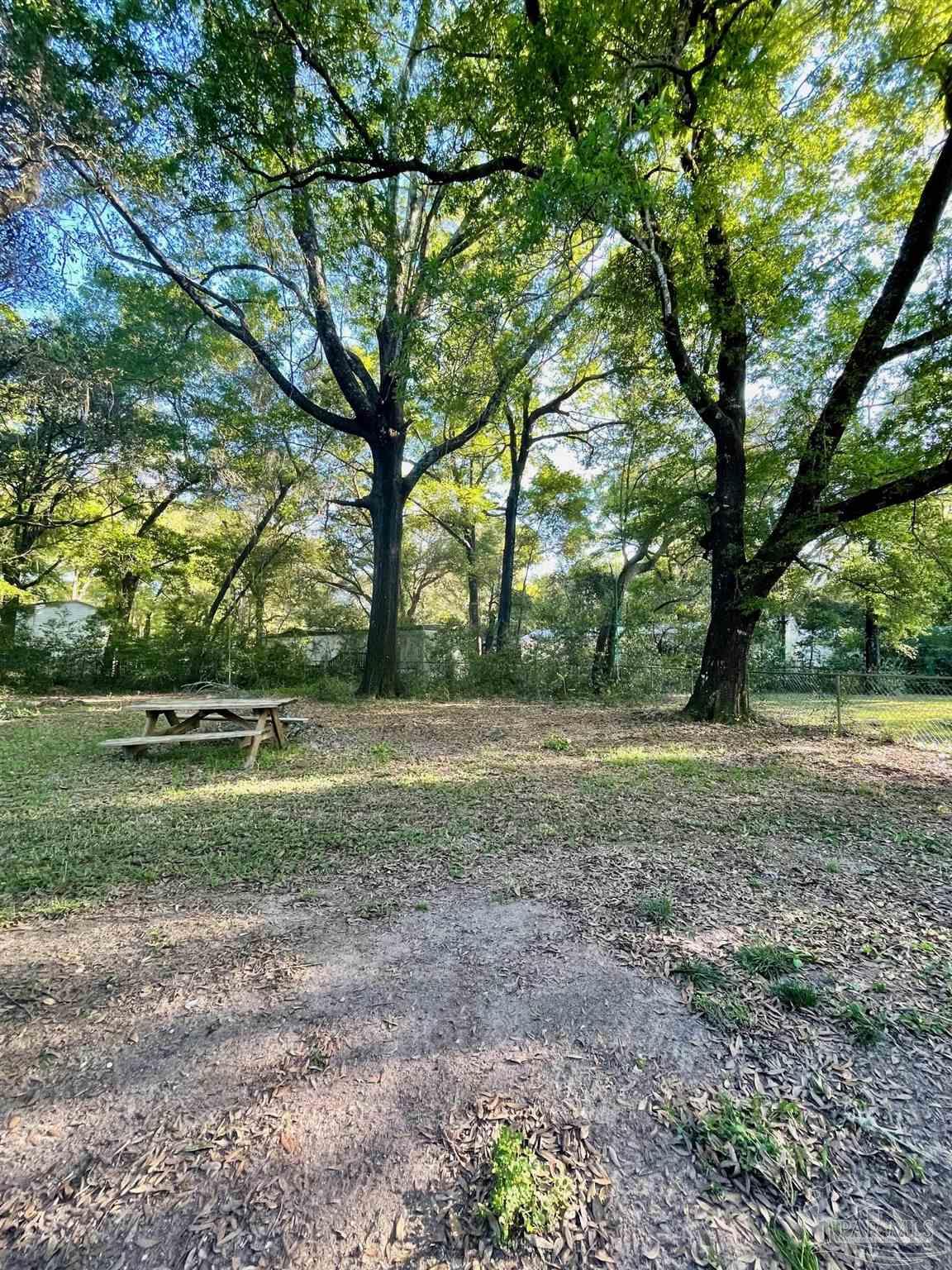 6455 Maddox Road Milton, FL 32570 - Photo 12 of 13 a view of outdoor space with trees