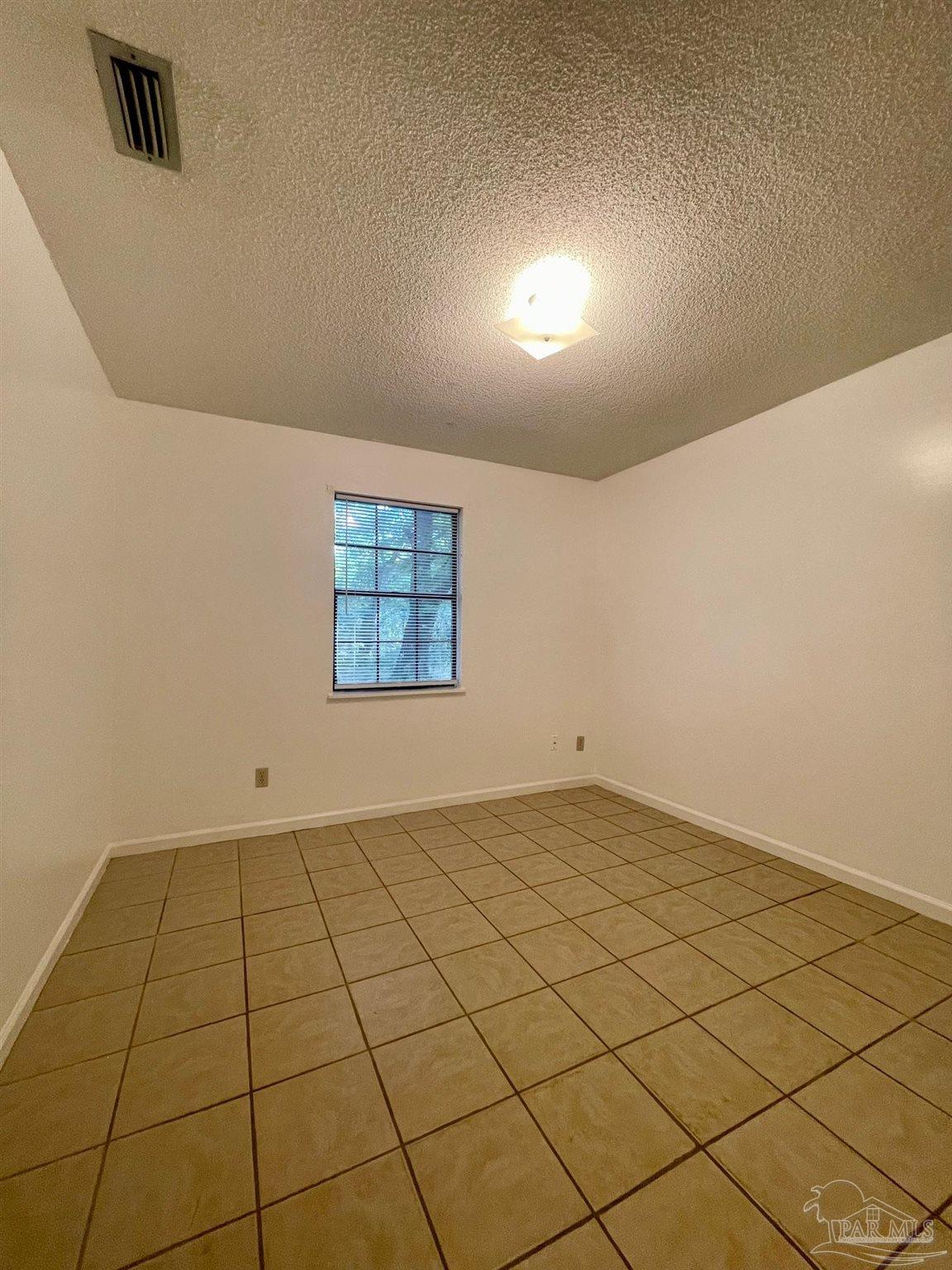 6455 Maddox Road Milton, FL 32570 - Photo 5 of 13 an empty room with windows
