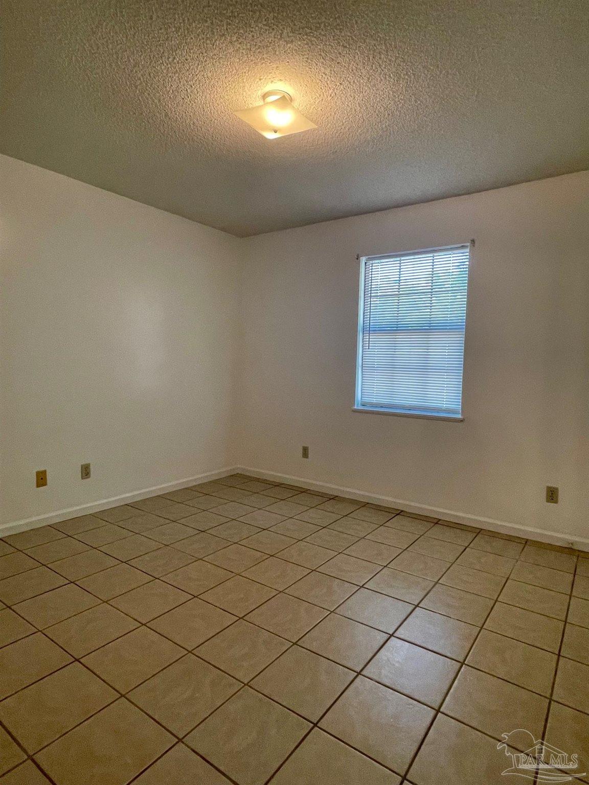 6455 Maddox Road Milton, FL 32570 - Photo 8 of 13 an empty room with windows