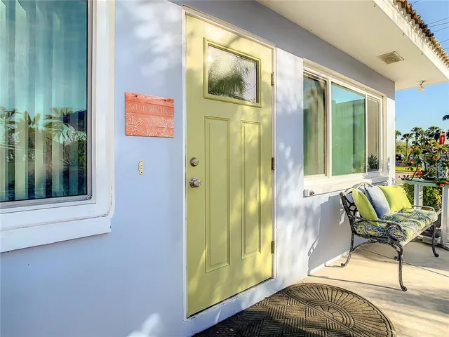 a front view of a house with a yard and a fountain