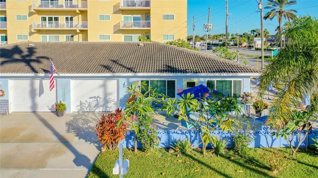 a front view of a multi story building with yard