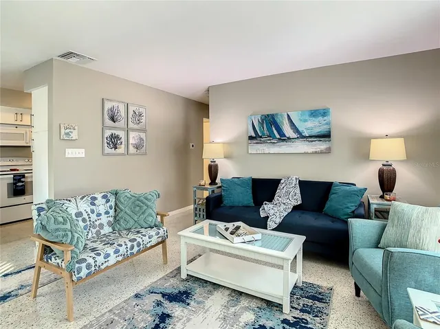 a kitchen with stainless steel appliances granite countertop a refrigerator and white cabinets