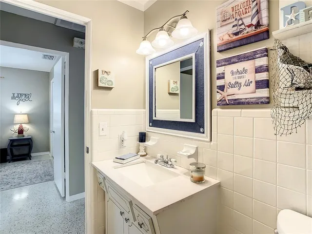 a bedroom with a bed and a chair with the view of entryway