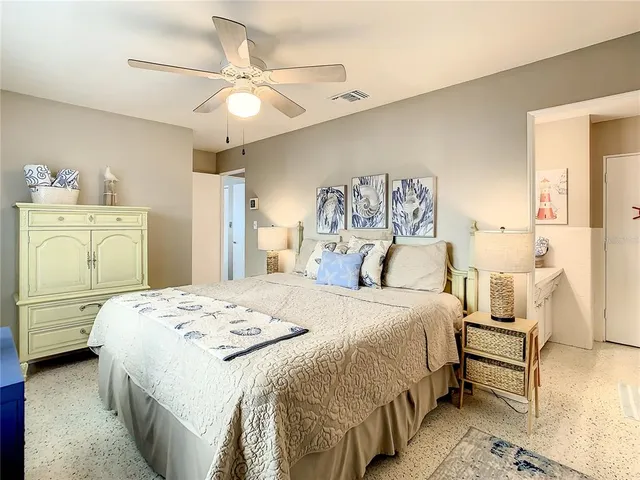 a view of a swimming pool with a lounge chair and tables