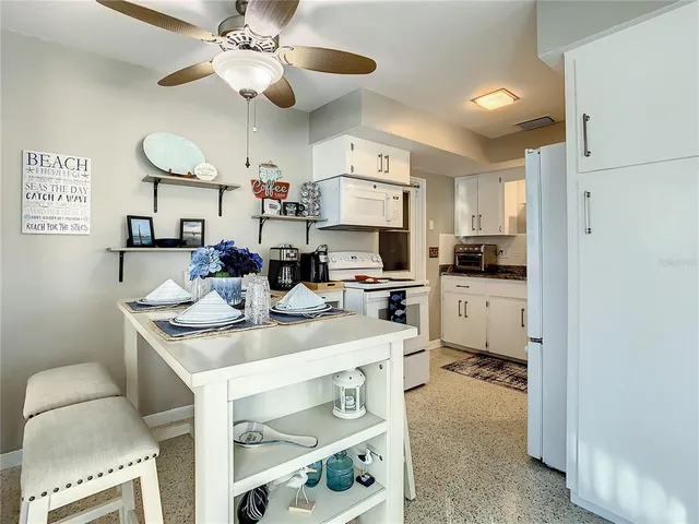 a kitchen with stainless steel appliances kitchen island granite countertop a sink and cabinets