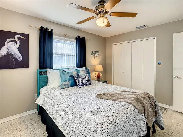 a view of patio with chairs and table under an umbrella