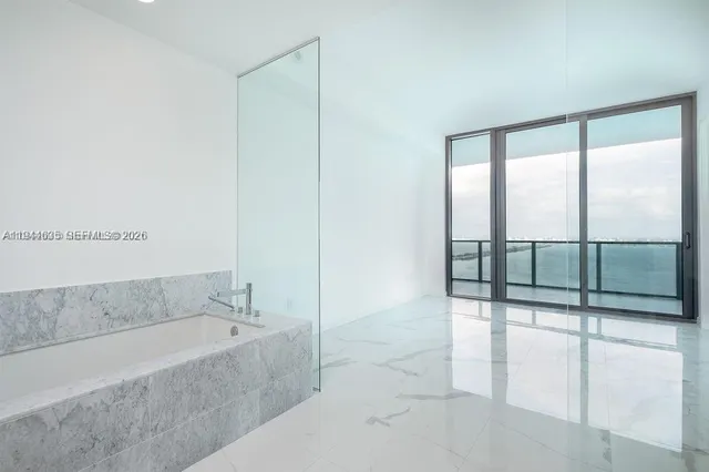 a bathroom with a tub and a shower