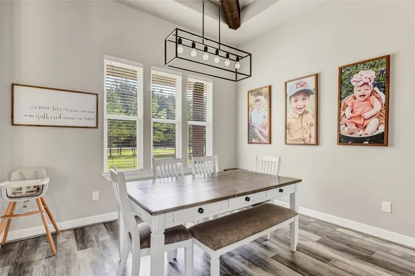 a large kitchen with a table and chairs