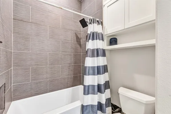 a bathroom with a bathtub and shower