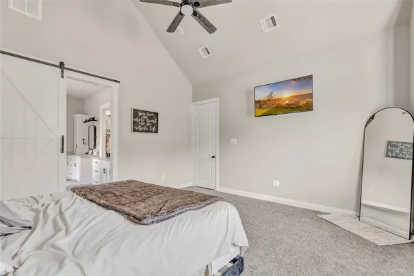 a large bathroom with a granite countertop double vanity sink a mirror and a bathtub