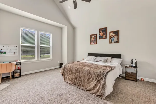 a spacious en suite bathroom with a double sink and mirror